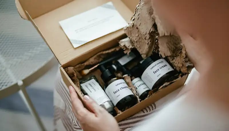 person-looking-into-a-box-of-beauty-products