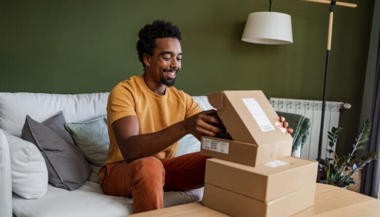Smiling-man-opening-a-delivery-box-768x439