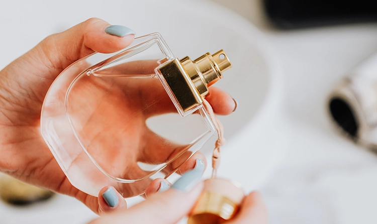Shot of someone's hand holding a luxury parfume