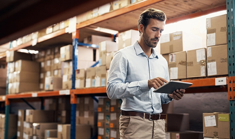 Manager in a warehouse with a tablet |