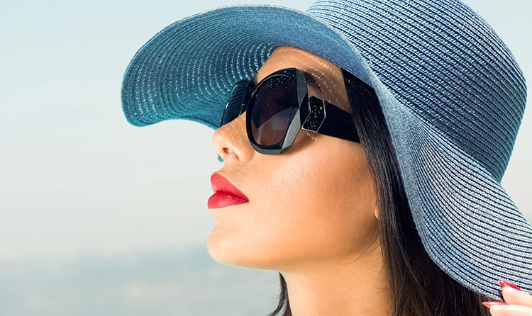 Woman with a blue hat black sunglasses and red lipstick 1 |