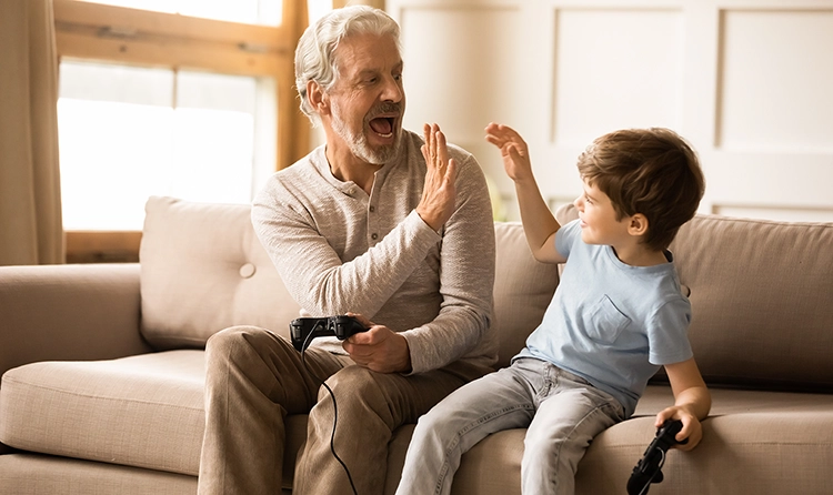 grandfather and grandson playing a video game